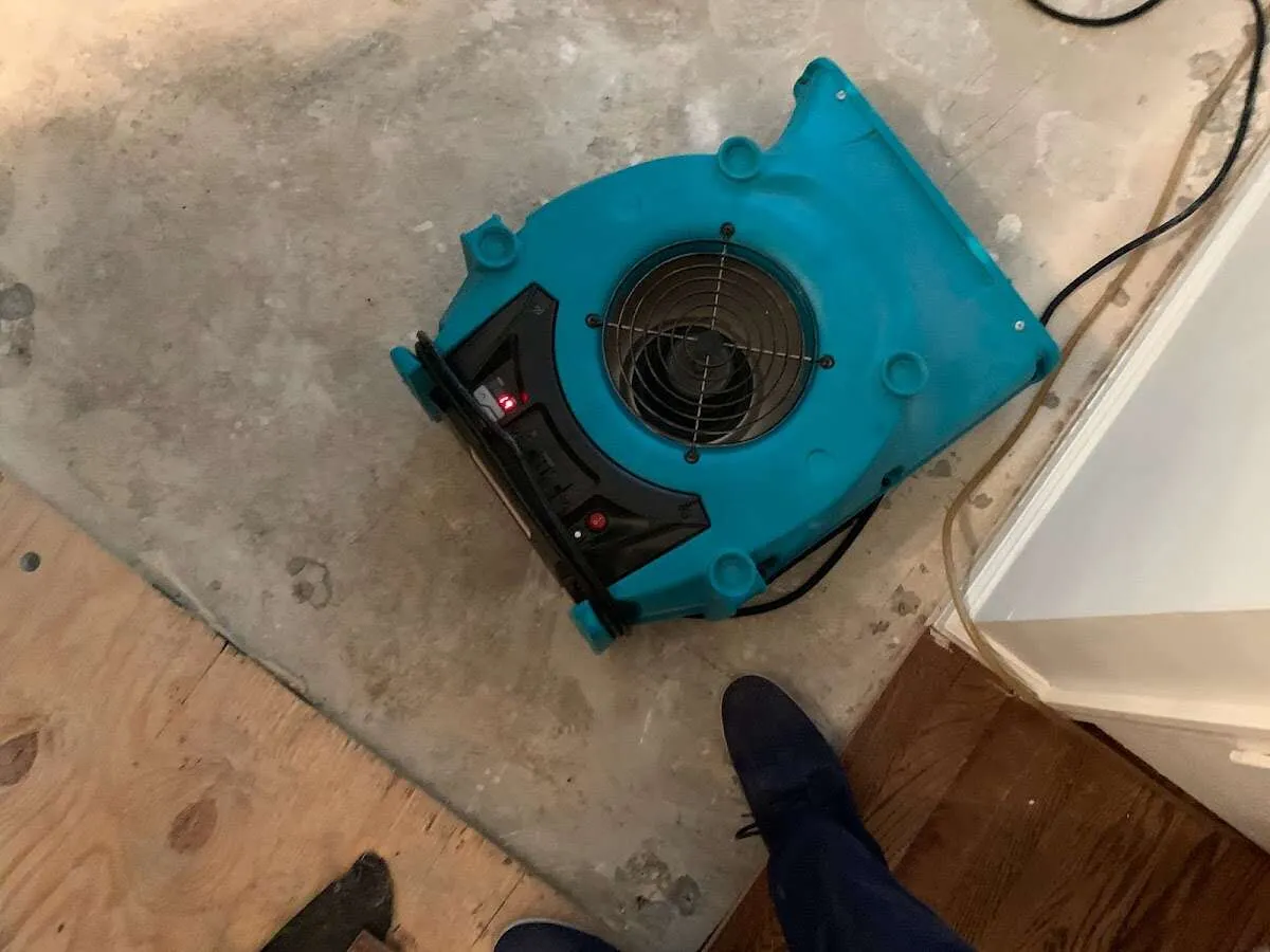 Air mover drying subfloor during Leak Detection & Repair in Middlebury